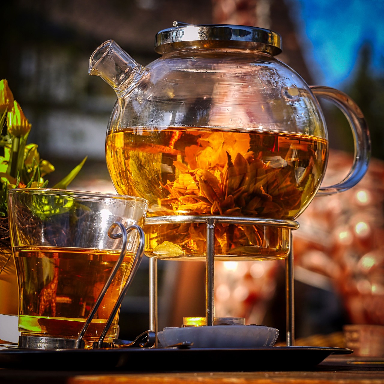Glass tea kettle with flowers infusing inside